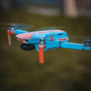 Close-up of a vibrant DJI drone in flight, showcasing modern aerial technology.