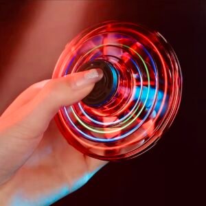 A disc-shaped LED flying UFO spinner with fingertip induction control, performing a hovering gyro flight with neon light effects.