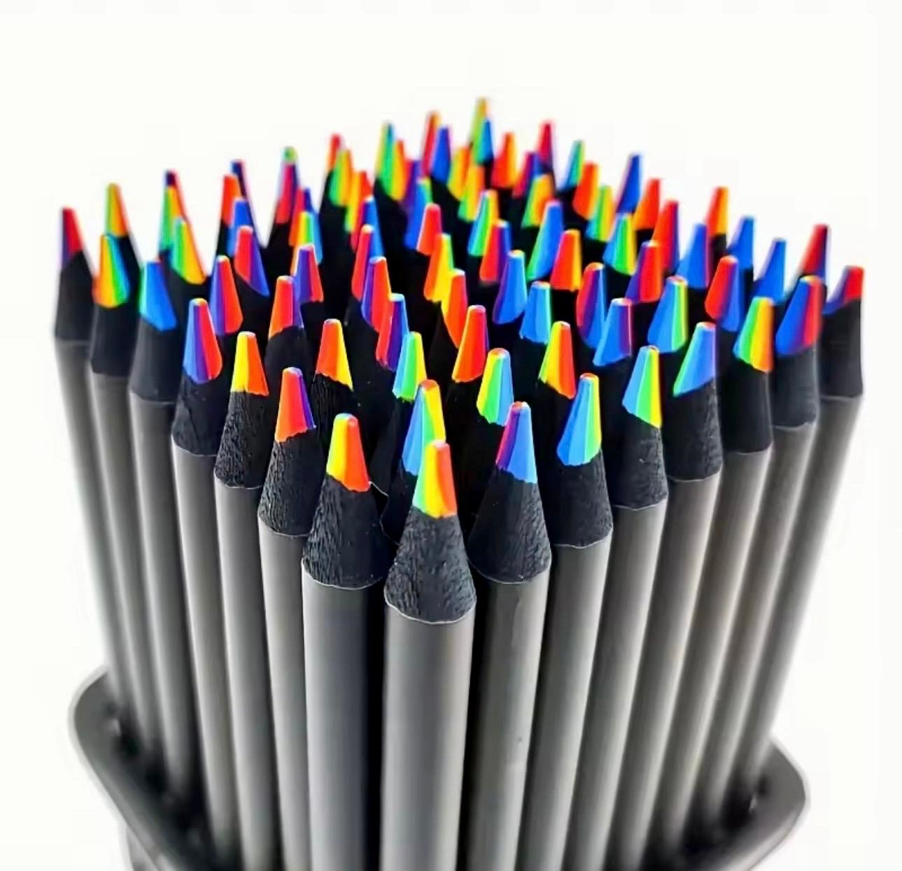 A set of rainbow-colored pencils showing the 7-color blended lead and an included manual pencil sharpener.
