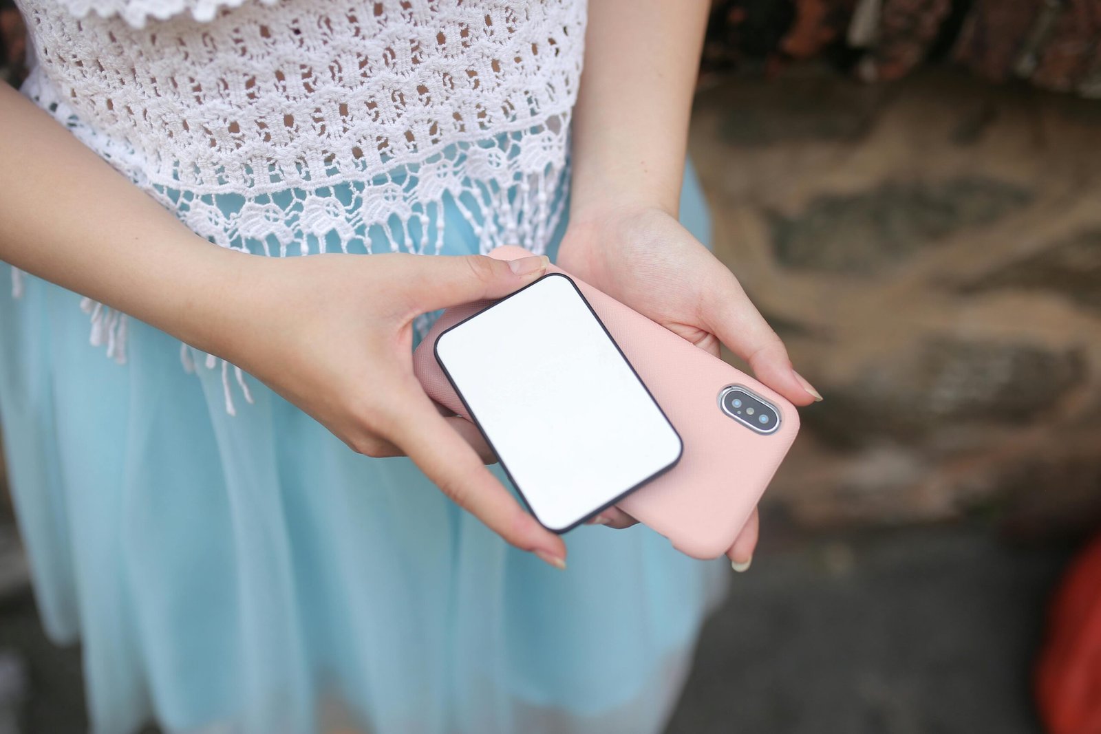 pexels photo 5147225 5147225 Close-up of a woman holding a smartphone and power bank, showcasing technology and connectivity.