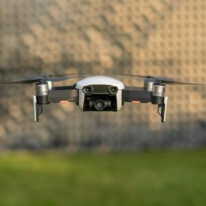 Drone in mid-flight against blurred outdoor background, showcasing technology.