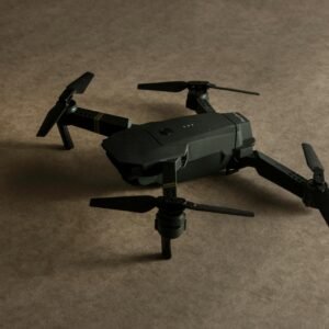 Detailed photo of a black drone toy on a textured surface, showcasing modern design.