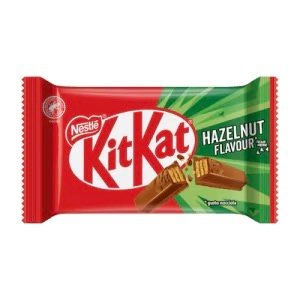 A wrapped Nestlé KitKat bar in red and green packaging, featuring the hazelnut flavor label and a cross-section of the chocolate-covered crispy wafer.