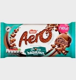 A Nestlé Aero Chocolate Hazelnut bar featuring aerated milk chocolate bubbles infused with rich hazelnut flavor.