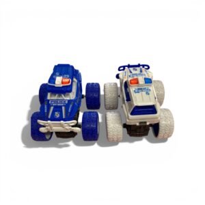 Two friction-powered police monster truck toys, one navy blue with blue tires and one white with white tires, featuring "Off-Road" and "Justice" decals.