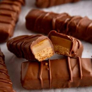 A standard Twix chocolate bar in its gold wrapper, featuring two fingers of crunchy biscuit and smooth caramel coated in milk chocolate.