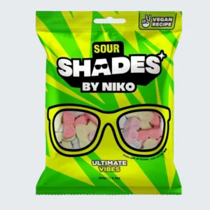 Front view of a 150g bag of Shades by Niko 'Sour Ultimate Vibes' sweets. The bright, modern packaging showcases the distinct 'Shades' mascot wearing sunglasses, stylized sour elements, and clear Vegan and European Halal certification badges.