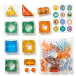 Complete contents of the 68-piece magnetic marble run set showing geometric tiles, tube slide pieces, stickers, and rolling balls